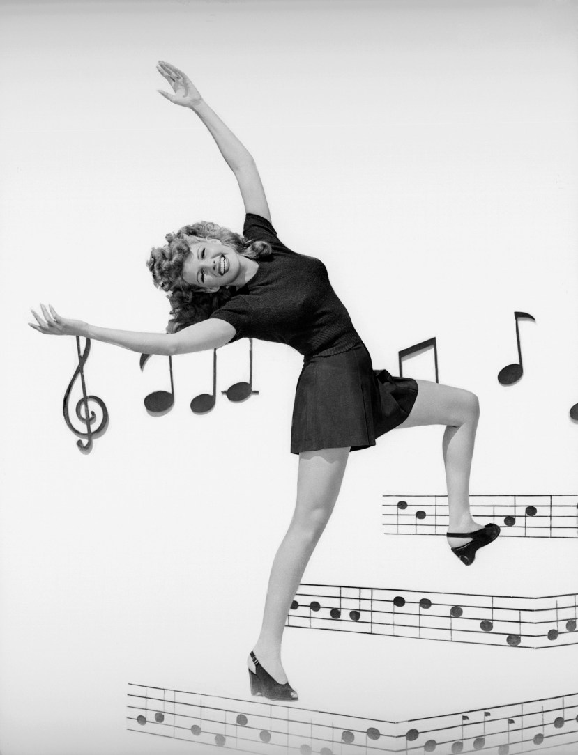 1944: Rita Hayworth (1918 - 1987) surrounded by musical notes and bars in the film 'Cover Girl', directed by Charles Vidor. (Photo by Ned Scott)